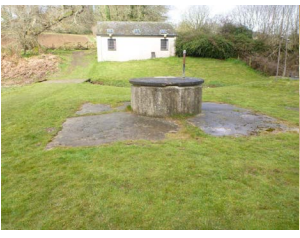 Figure 18: Old Well Headworks in foreground and pump house in background.